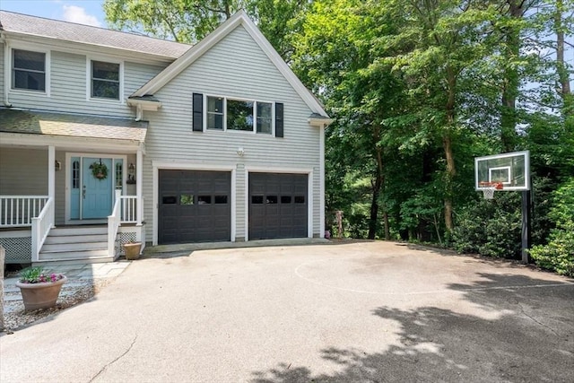 12 Whitcomb Ln, Hingham, MA 02043 - view of front of home with an attached garage, a shingled roof, covered porch, and driveway