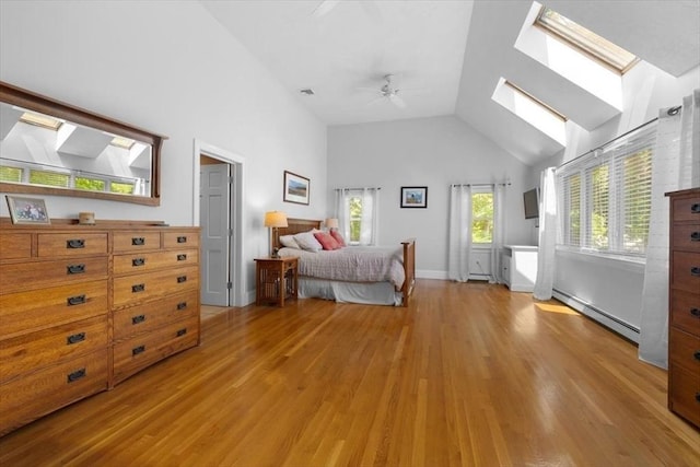 12 Whitcomb Ln, Hingham, MA 02043 - bedroom featuring a skylight, baseboard heating, light wood-type flooring, high vaulted ceiling, and a ceiling fan