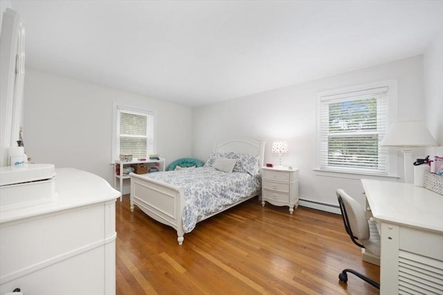 12 Whitcomb Ln, Hingham, MA 02043 - bedroom featuring multiple windows, baseboard heating, light wood-style flooring, and a desk