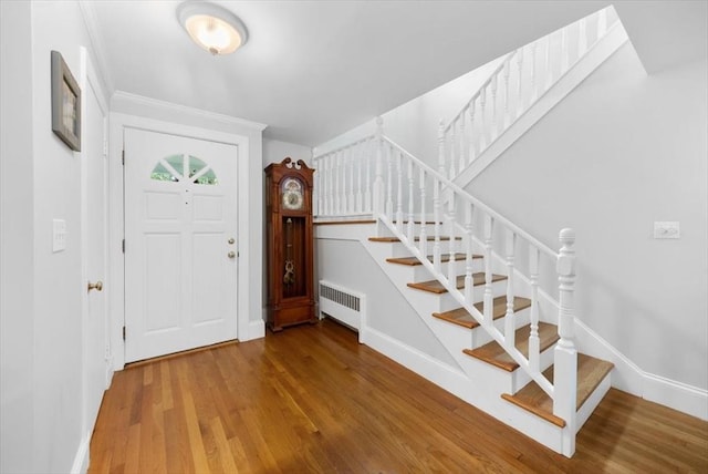 12 Whitcomb Ln, Hingham, MA 02043 - foyer entrance featuring radiator heating unit, stairway, and wood finished floors