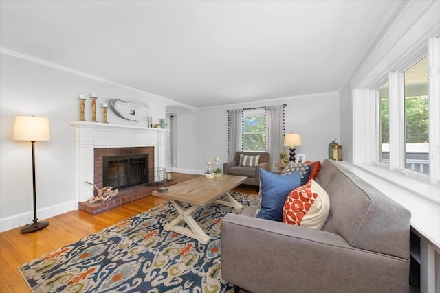 12 Whitcomb Ln, Hingham, MA 02043 - living room with wood finished floors, a brick fireplace, and crown molding