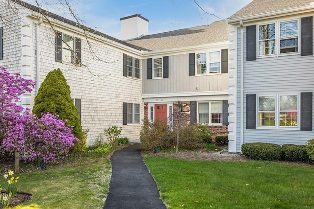 33 Highview Dr Unit 33, Sandwich, MA 02563 - view of front of house with a shingled roof, a front yard, and a chimney