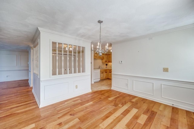 33 Highview Dr Unit 33, Sandwich, MA 02563 - unfurnished dining area featuring crown molding, wainscoting, a decorative wall, a chandelier, and light wood finished floors