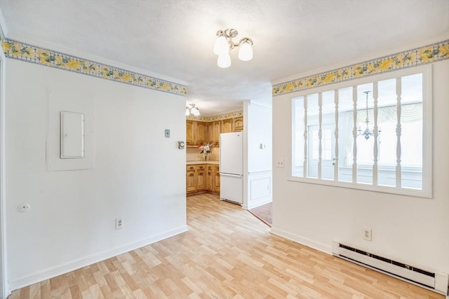 33 Highview Dr Unit 33, Sandwich, MA 02563 - spare room featuring light wood-style floors, baseboards, a baseboard radiator, and a chandelier