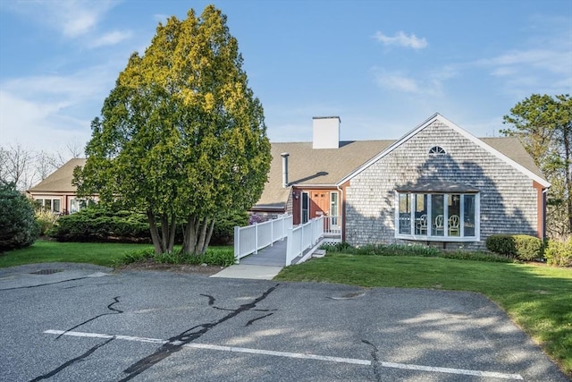 33 Highview Dr Unit 33, Sandwich, MA 02563 - view of front of home with roof with shingles, a chimney, and a front yard