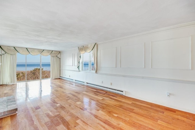 33 Highview Dr Unit 33, Sandwich, MA 02563 - unfurnished living room with a water view, a baseboard heating unit, a wealth of natural light, and light wood-type flooring