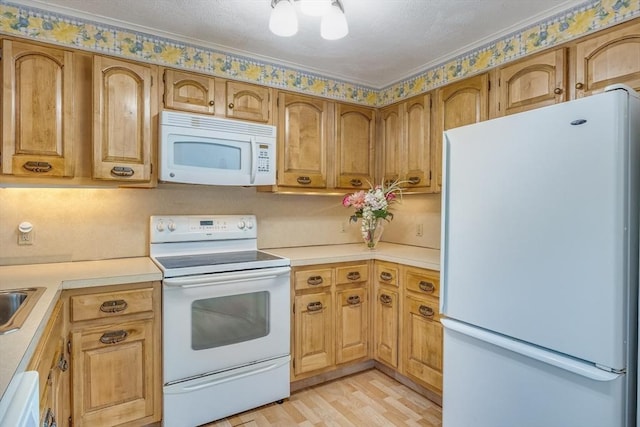 33 Highview Dr Unit 33, Sandwich, MA 02563 - kitchen with light countertops, light wood-type flooring, white appliances, and a sink