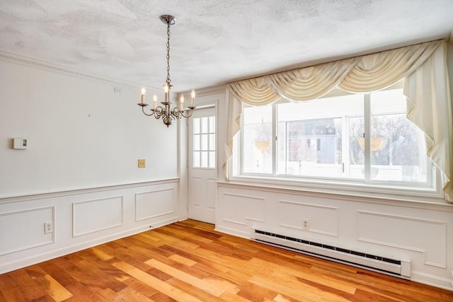 33 Highview Dr Unit 33, Sandwich, MA 02563 - unfurnished dining area with baseboard heating, a decorative wall, light wood finished floors, and a chandelier