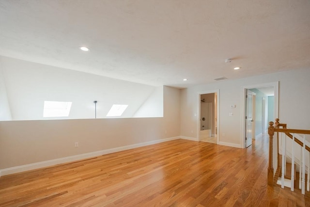 10 Chase Lndg Unit B, Easton, MA 02375 - empty room featuring a skylight, light wood-style flooring, recessed lighting, baseboards, and vaulted ceiling