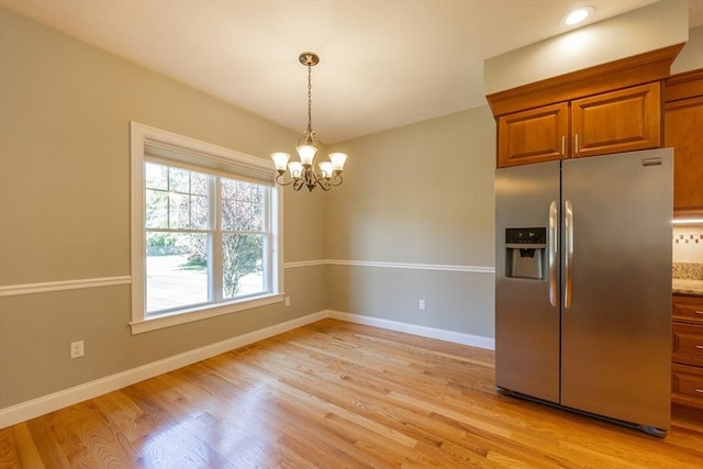 10 Chase Lndg Unit B, Easton, MA 02375 - kitchen with stainless steel fridge with ice dispenser, a chandelier, brown cabinetry, light wood-style flooring, and baseboards