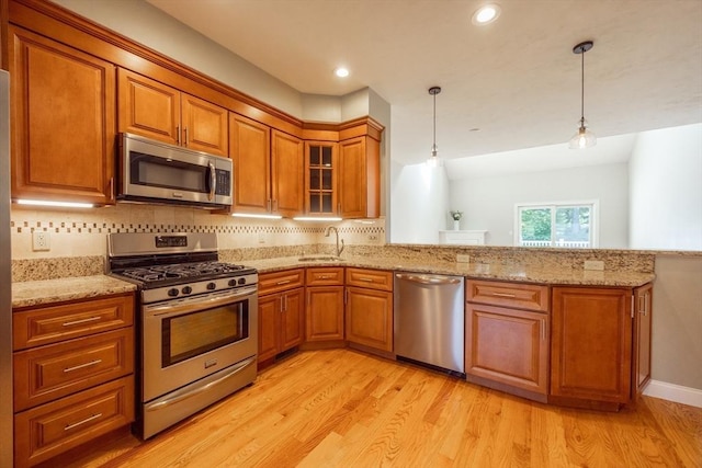 10 Chase Lndg Unit B, Easton, MA 02375 - kitchen featuring stainless steel appliances, a sink, brown cabinetry, light wood-style flooring, and recessed lighting