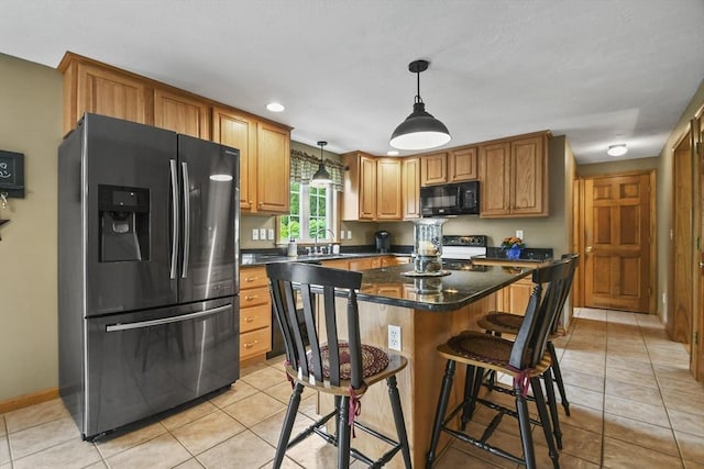 18 Jackson Ave, Rutland, MA 01543 - kitchen featuring fridge with ice dispenser, black microwave, light tile patterned floors, a sink, and stove