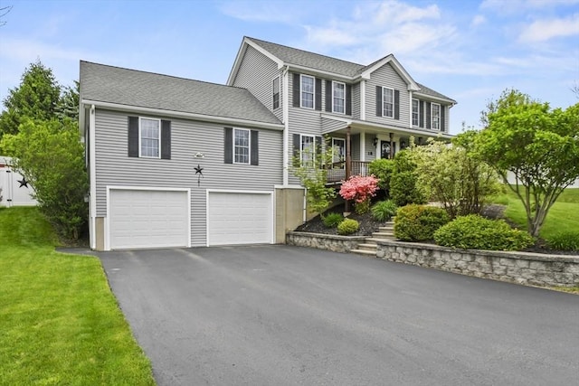18 Jackson Ave, Rutland, MA 01543 - view of front of property featuring driveway, an attached garage, and a front yard