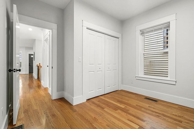 50 Cottage St Unit 1, Chelsea, MA 02150 - unfurnished bedroom with baseboards, light wood-style flooring, and a closet