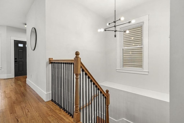 50 Cottage St Unit 1, Chelsea, MA 02150 - stairway with wood finished floors, a chandelier, and baseboards