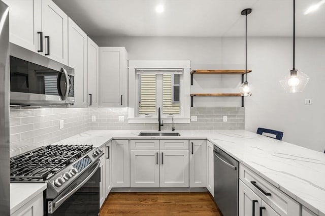 50 Cottage St Unit 1, Chelsea, MA 02150 - kitchen with appliances with stainless steel finishes, a sink, tasteful backsplash, light stone counters, and dark wood-type flooring
