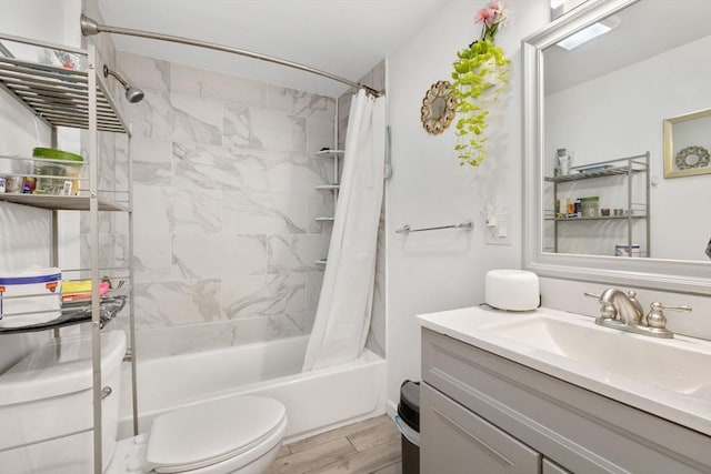 bathroom featuring vanity, toilet, shower / tub combo, and wood finished floors