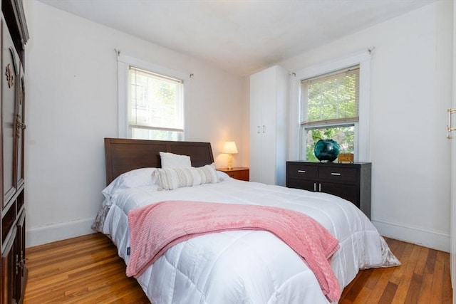 bedroom featuring baseboards and wood finished floors