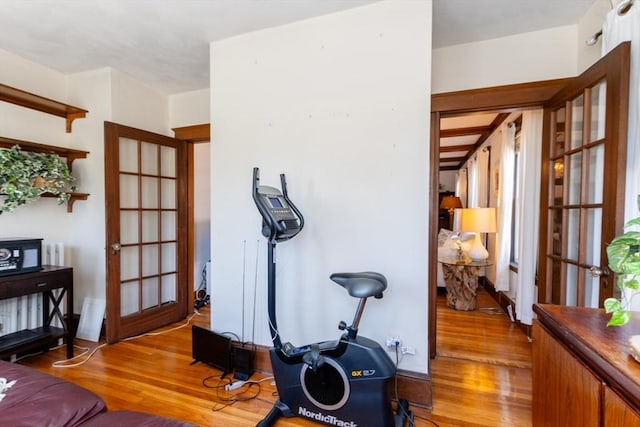 exercise room featuring wood finished floors