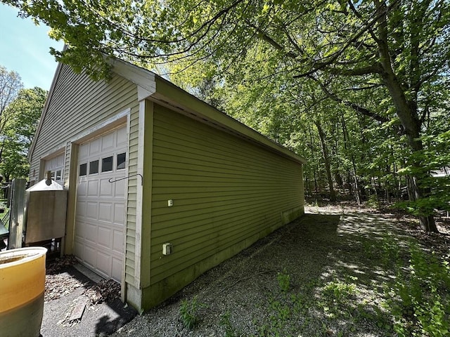 view of side of home with an outbuilding and a detached garage
