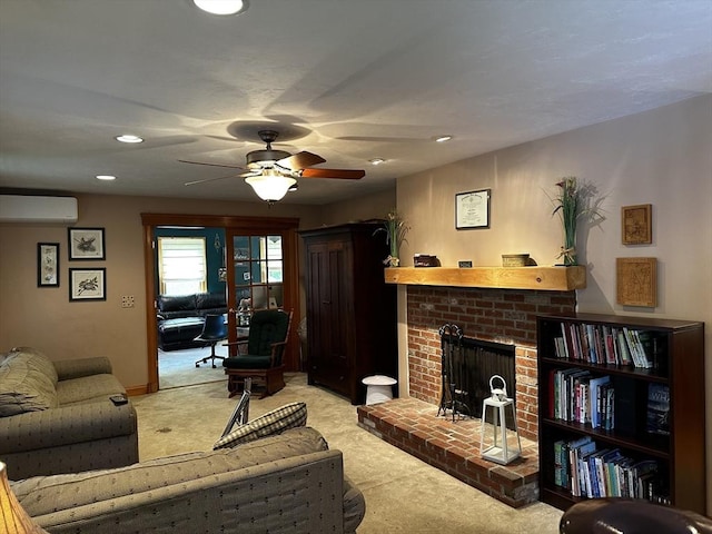 carpeted living area featuring a wall mounted air conditioner, ceiling fan, a brick fireplace, and recessed lighting