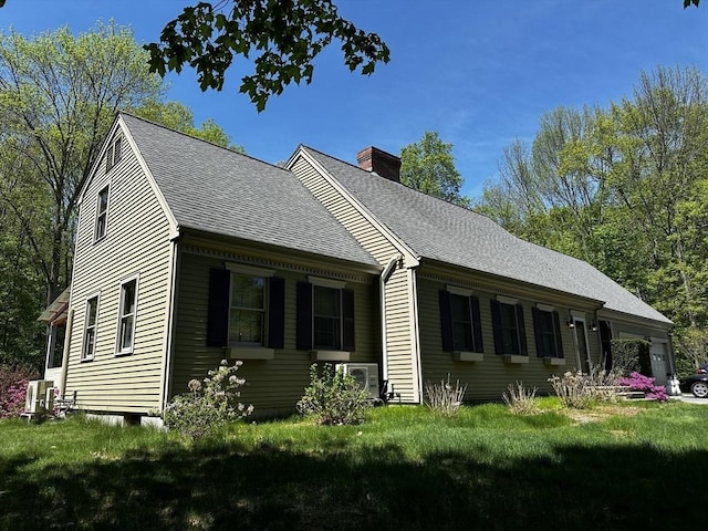 view of home's exterior with a chimney, roof with shingles, a lawn, and central air condition unit