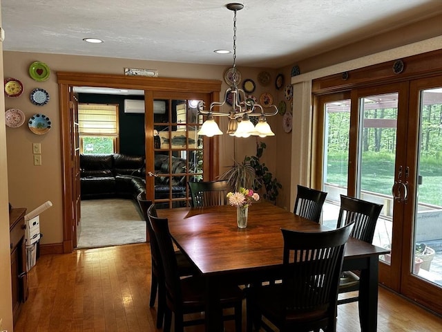 dining room with a chandelier, light wood-style flooring, recessed lighting, and baseboards