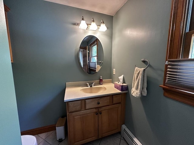 half bath featuring tile patterned flooring, vanity, and baseboards