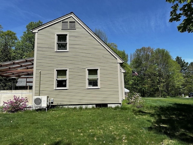view of property exterior with a yard and a cooling unit