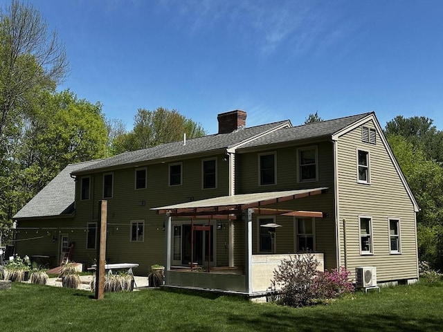 back of property with a chimney, a yard, a cooling unit, a sunroom, and a patio