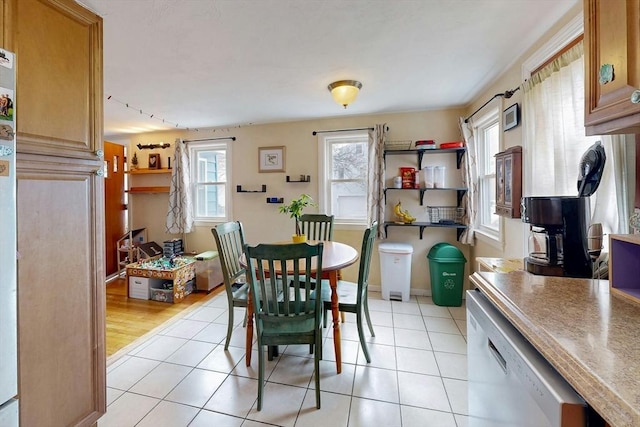 dining room with light tile patterned floors and baseboards