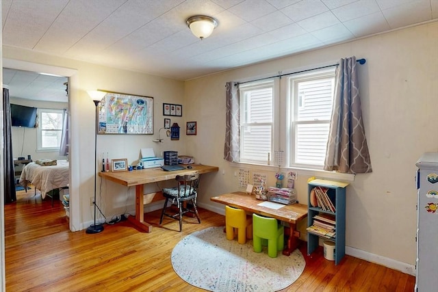 office area with light wood-type flooring and baseboards