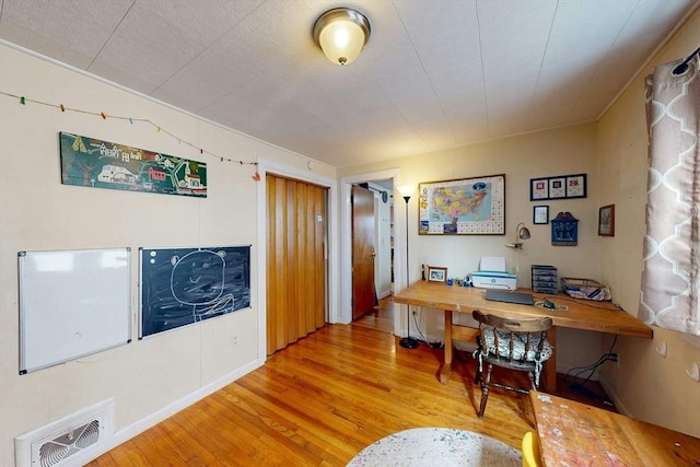 office area with wood finished floors and visible vents