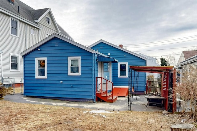 back of house featuring fence