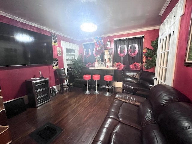 living room featuring hardwood / wood-style floors, crown molding, and french doors