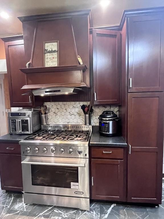 kitchen with decorative backsplash, high end stainless steel range, and premium range hood