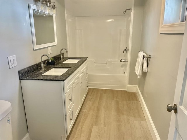 43 Aubin St Unit 1, Amesbury, MA 01913 - full bathroom featuring wood finished floors, bathing tub / shower combination, double vanity, toilet, and baseboards