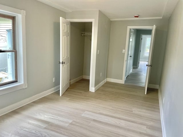 43 Aubin St Unit 1, Amesbury, MA 01913 - unfurnished bedroom with light wood-style floors, baseboards, and a closet