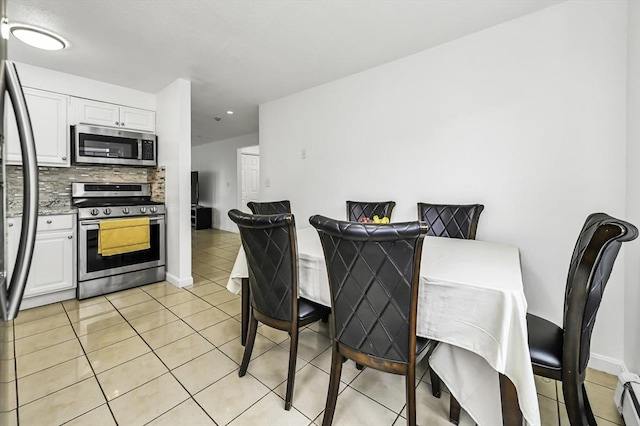 312 Water St Unit 1, Lawrence, MA 01841 - dining area featuring light tile patterned flooring, baseboard heating, and baseboards