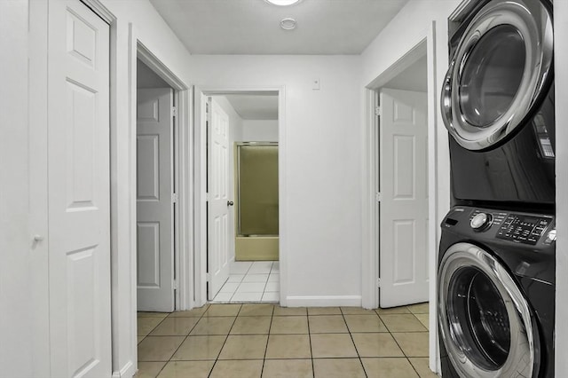 312 Water St Unit 1, Lawrence, MA 01841 - laundry area with stacked washer / dryer, light tile patterned floors, and baseboards