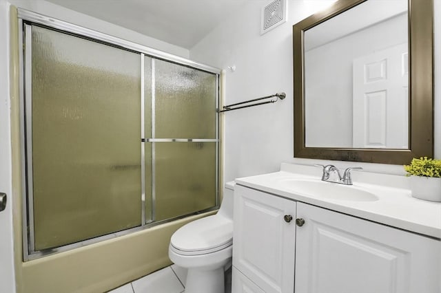 312 Water St Unit 1, Lawrence, MA 01841 - bathroom featuring vanity, toilet, bath / shower combo with glass door, and tile patterned floors