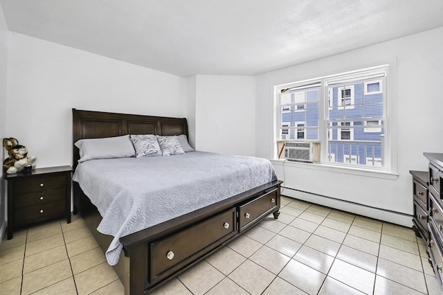 312 Water St Unit 1, Lawrence, MA 01841 - bedroom with a baseboard heating unit, light tile patterned flooring, and cooling unit