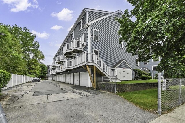 312 Water St Unit 1, Lawrence, MA 01841 - view of building exterior featuring stairs and a garage