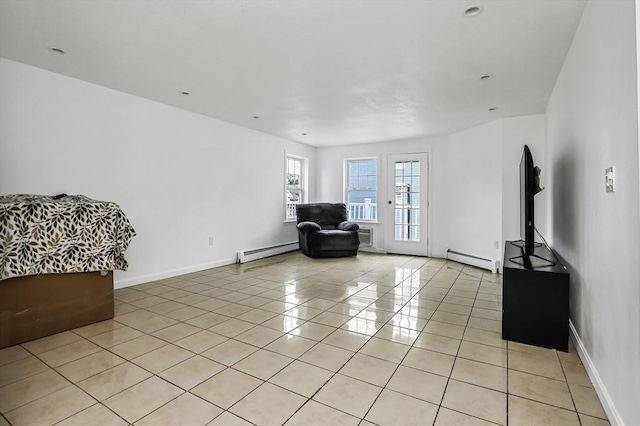 312 Water St Unit 1, Lawrence, MA 01841 - living area featuring a baseboard radiator, light tile patterned flooring, and baseboards