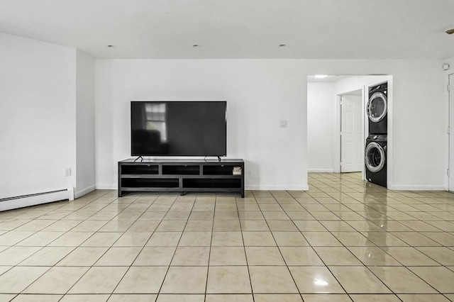 312 Water St Unit 1, Lawrence, MA 01841 - living room with stacked washing machine and dryer, baseboards, light tile patterned floors, and baseboard heating