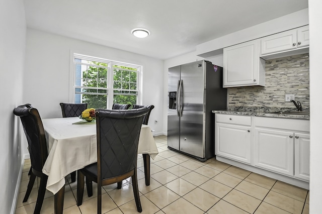 312 Water St Unit 1, Lawrence, MA 01841 - kitchen featuring stainless steel fridge with ice dispenser, backsplash, white cabinetry, a sink, and stone countertops