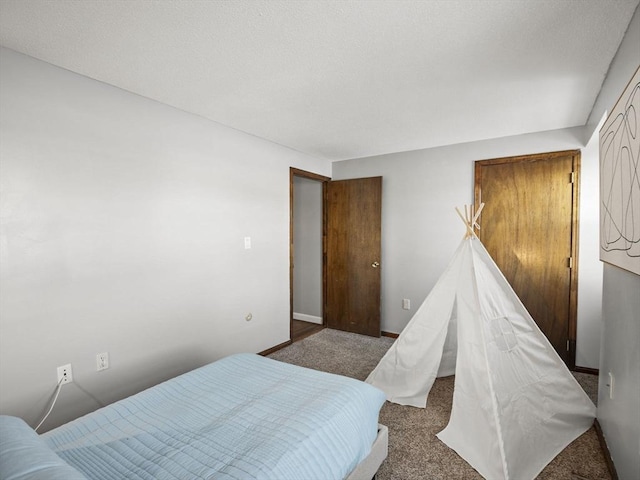 bedroom with carpet floors and baseboards