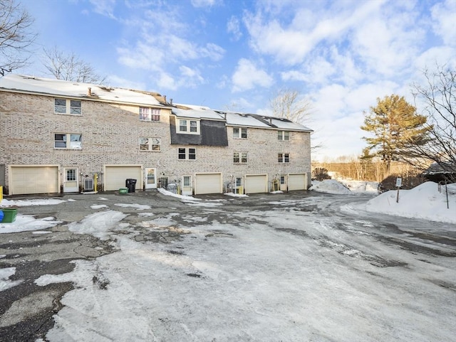 snow covered rear of property with central AC unit