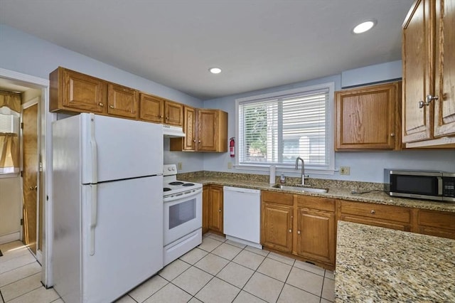 15 Hamilton St, Boston, MA 02136 - kitchen featuring white appliances, under cabinet range hood, brown cabinets, light tile patterned floors, and light stone countertops