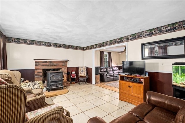 living room featuring a wood stove and light tile patterned floors